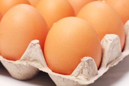 Eggs in a paper package on white background