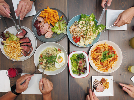 Top view of four people having dinnerの写真素材