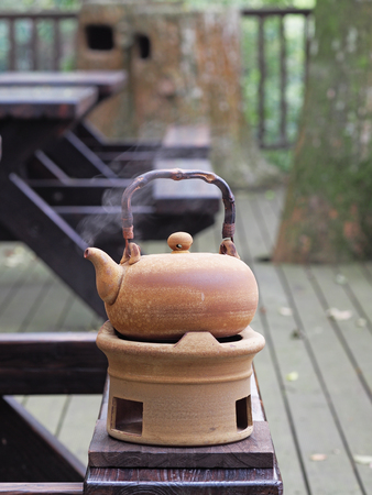Old kettle put on a fireplace for hot drinkの写真素材