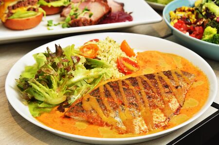 Fried sea bass with vegetables and sauce