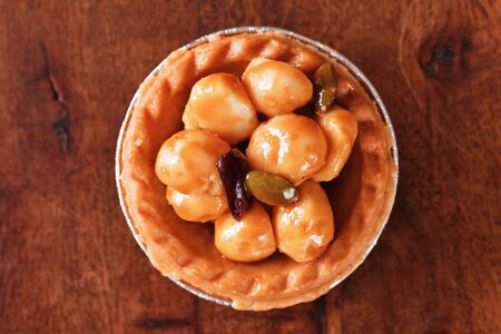 Macadamia nuts tart on wooden tableの写真素材