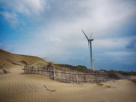 Beautiful dune and windmill in the beach dunes hill at Guanyin, Taiwan