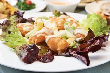 Fried shrimp ball with salad on white plate