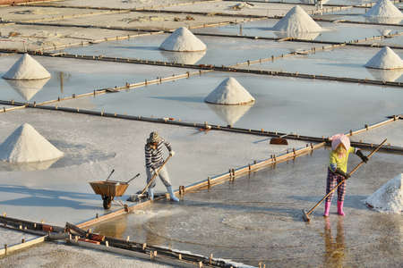 March 26, 2020: People workingon on salt pans at Tainan coast, Taiwan.のeditorial素材