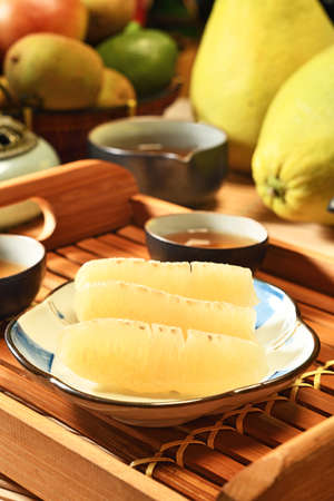 Fresh peeled pomelo on plate