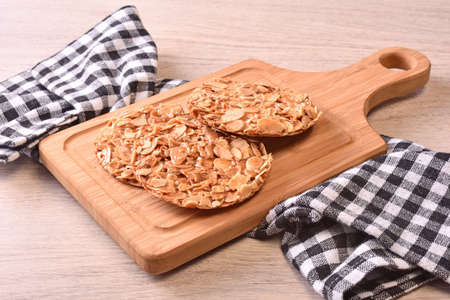 Round shortbread almond biscuits on wooden tray