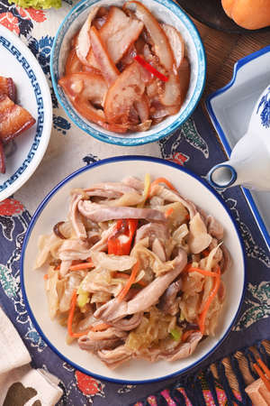 Stir-fried Chinese sauerkraut with pork stomach on the white plateの写真素材