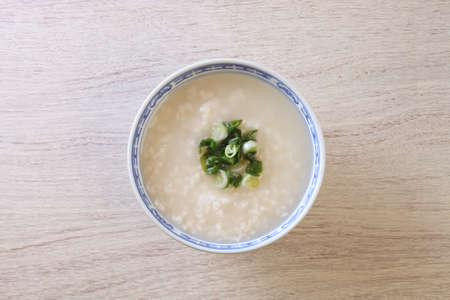 Rice porridge with spring onion on the table
