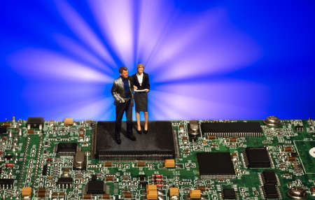 Miniature people businessman standing on electronic circuit board