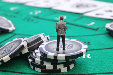 Miniature people figure businessman standing on casino chips, Gambling conceptの写真素材
