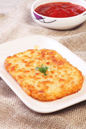 Hash browns on white plateの写真素材