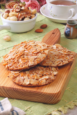 Almond florentine cookies on wooden trayの写真素材