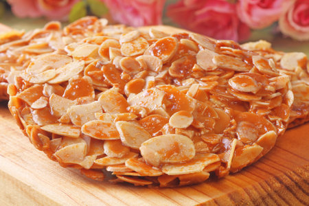 Almond florentine cookies on wooden trayの写真素材