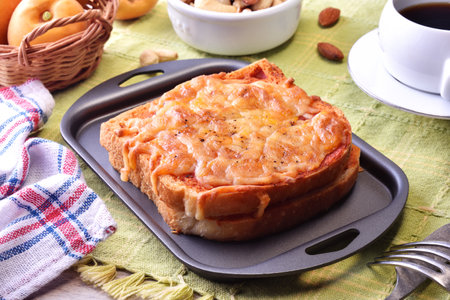 Pizza toasted bread with tomato sauce on a black plateの写真素材