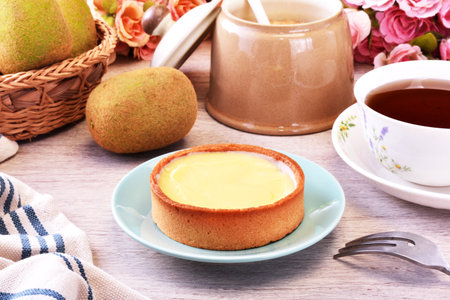 Lemon tart on a plate with hot teaの写真素材