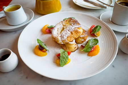 French toast with apricot and coffee in white platele tableの写真素材