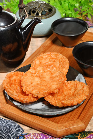 Japanese food, Deep-fried doughstick in black plate on wooden tableの写真素材