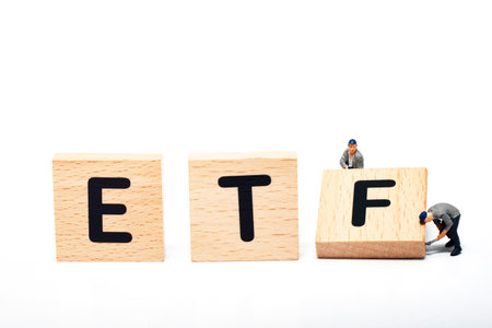 ETF wooden text block and miniature people worker on white background. Concept of Investment property.の写真素材