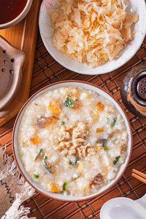 Minced pork congee with preserved egg on the tableの写真素材