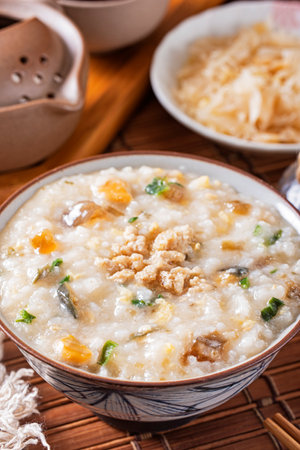 Minced pork congee with preserved egg on the tableの写真素材
