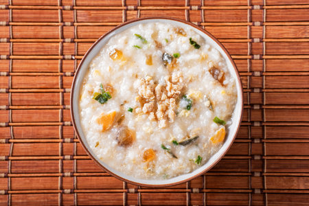 Minced pork congee with preserved egg on the tableの写真素材