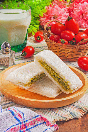 Matcha butter cream with white chocolate chip toast on wooden plateの写真素材