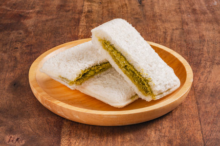 Matcha butter cream with white chocolate chip toast on wooden plateの写真素材