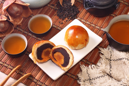 Two halves of egg yolk cakes on white plate
