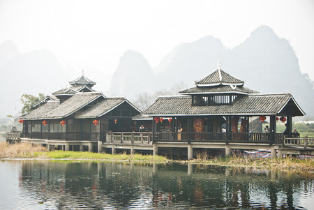 Reflection of a winter village - reflection of village houses on calm waterのeditorial素材
