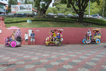 Decorated trishaw with colorful flowers and doll for hire at Malacca city, Malaysia. - A popular...