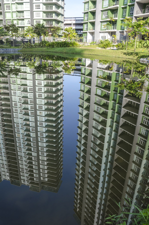 Tranquil lake with reflection of building and sky - the heaven reflection of lake in Ipoh, Malaysiaの写真素材