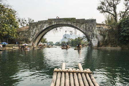 Guilin, China - Tourists taking bamboo raft rides during winter season in the Yulong River or Dragon River in Yangshuo near Guilin in southern China. - Bamboo rafting along Yulong River during the winter season with beauty of the landscape is a popular acのeditorial素材