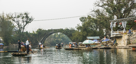 Guilin, China - Tourists taking bamboo raft rides during winter season in the Yulong River or Dragon River in Yangshuo near Guilin in southern China. - Bamboo rafting along Yulong River during the winter season with beauty of the landscape is a popular acのeditorial素材