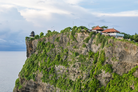 High Cliff at Uluwatu Temple, Bali, Indonesia - A scenic Uluwatu Cliff with pavilion and blue sea in Bali Indonesia.の写真素材