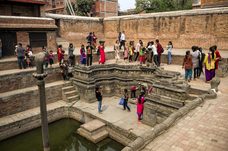 Unidentified vistors visiting the famous Snake Pond at the Royal Palace, Bhaktapur, Nepal. It also known as Nagh Pokari which was the royal bathing tank built in early 16th century.のeditorial素材