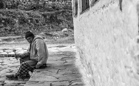 An unidentified bhutanese on pilgrimage spinning tibetan buddhist prayer wheel at Kyichu Lhakhang Temple, Paro, Bhutanのeditorial素材
