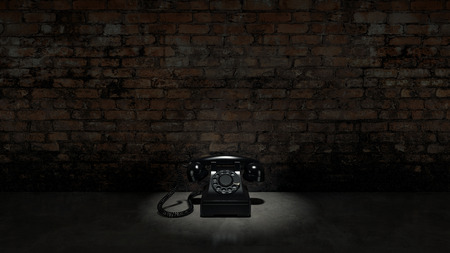 Old black telephone on brick wallの写真素材