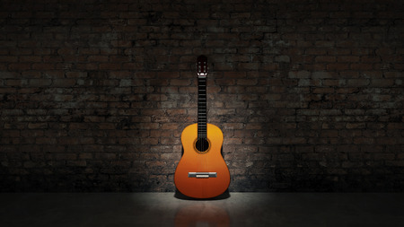 Acoustic guitar leaning on grungy wallの写真素材