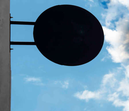 Black circle badge with sky and cloudsの写真素材