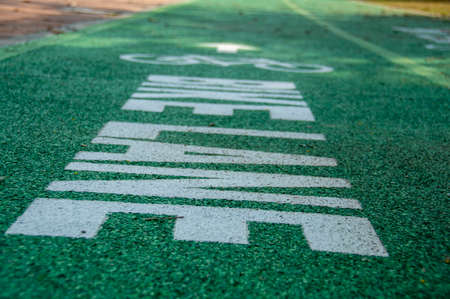 The green bicycle lane has blurred text on the back.の写真素材