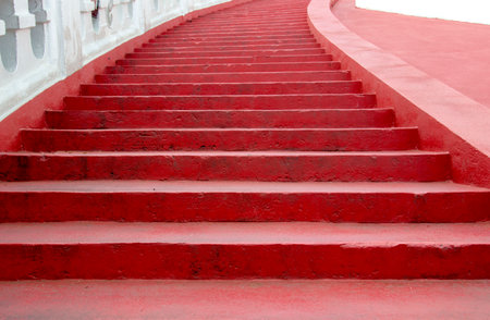 The curved staircase is painted red on every step.の写真素材