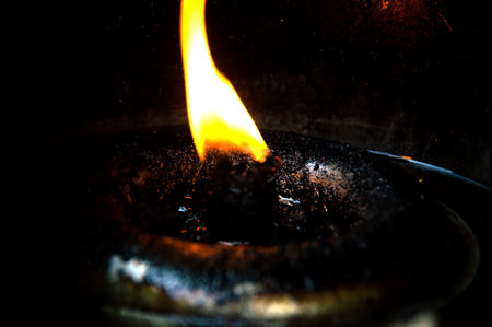The flame in the oil lamp had a slick of oil on it.