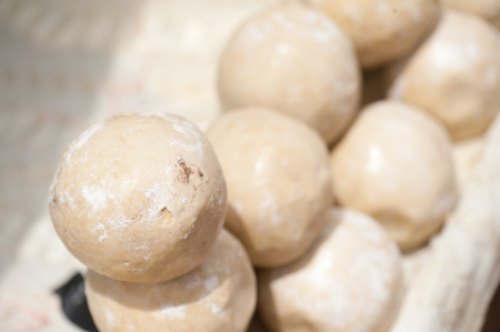 Closeup of raw cereal balls used for making bread in a dirty street of Djenne, Mali - Africaの写真素材