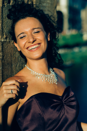 Young cute brunette portrait posing at sunsetの写真素材