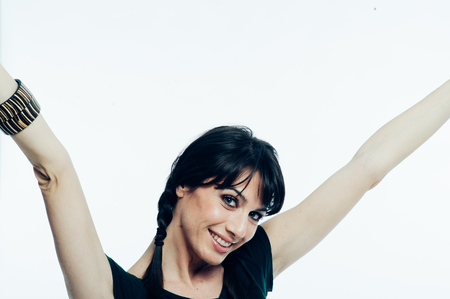 Young caucasian brunette with tail hair having fun in studio. White background, green shirt dressed. Copy spaceの写真素材