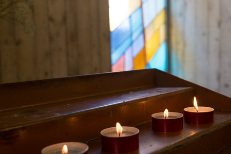 Row of ceremony candles in a modern churchの写真素材