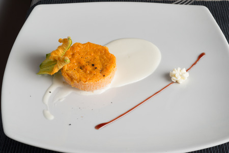 Pumpkin savory cupcake on a pecorino cheese cream tablematの写真素材
