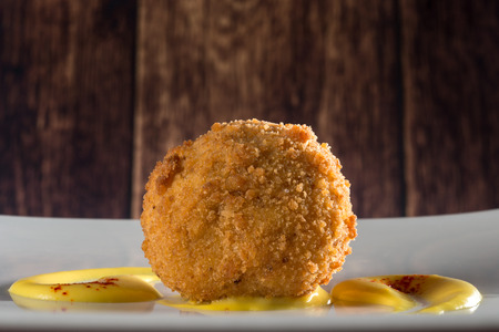 rice ball with tomato and cream on white dishの写真素材