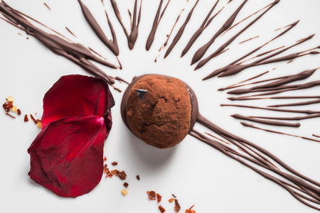 chocolate ball with chilli pepper on a white dishの写真素材