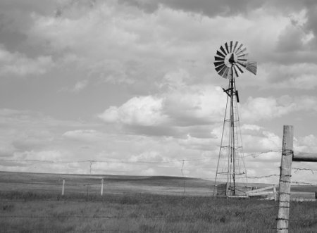 Windmill on the prairie in wide open spaces on a summer dayの写真素材
